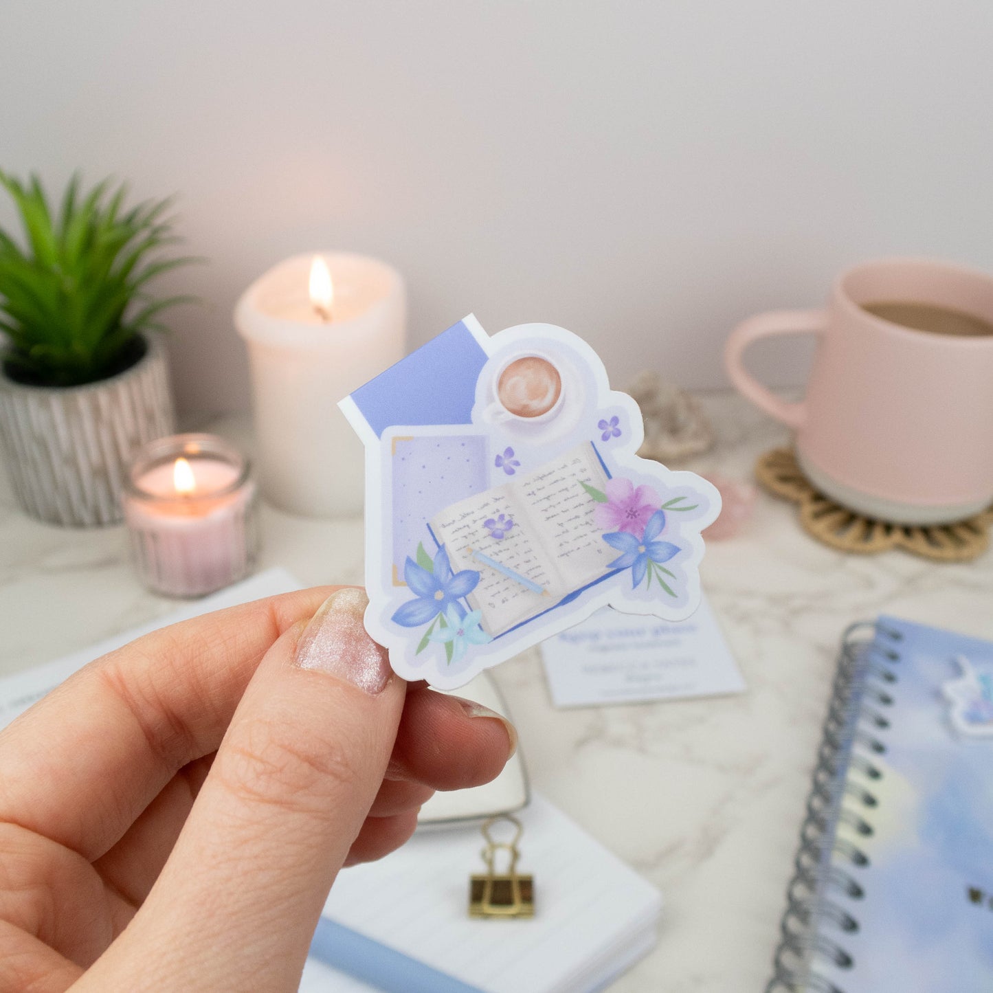 Magnetic bookmark featuring an open book, pastel flowers, and a coffee cup, perfect for planners and books.