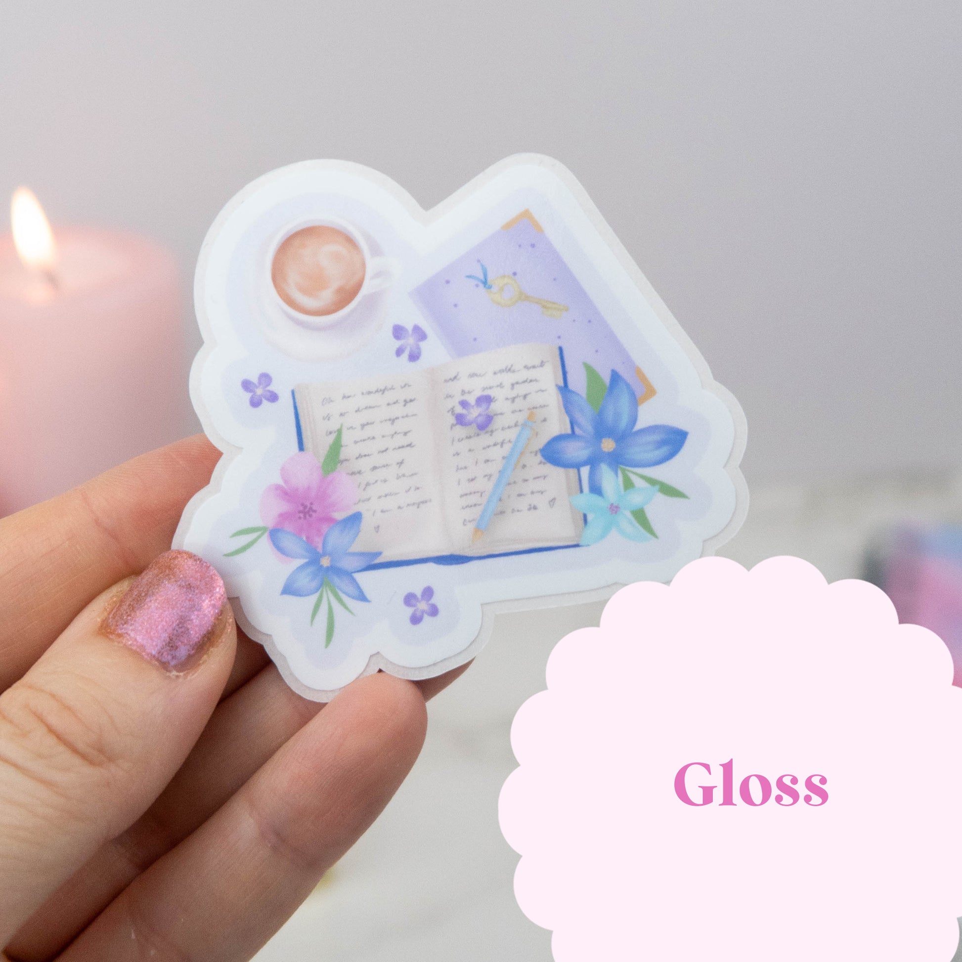 Decorative item with floral and book design held by a hand, with 'Gloss' text in the corner.