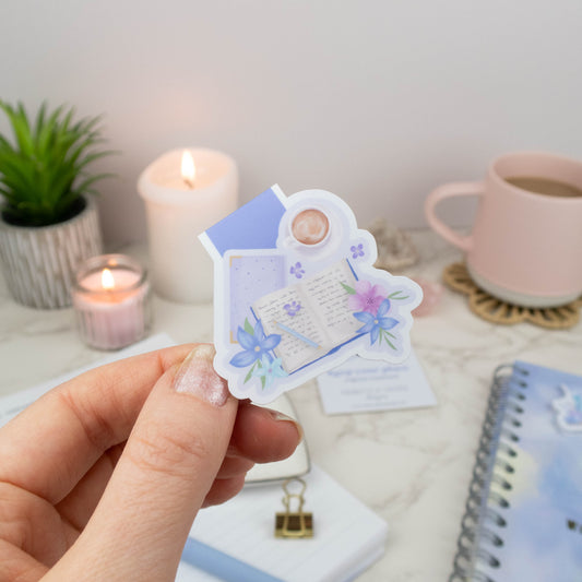 Magnetic bookmark featuring an open book, pastel flowers, and a coffee cup, perfect for planners and books.